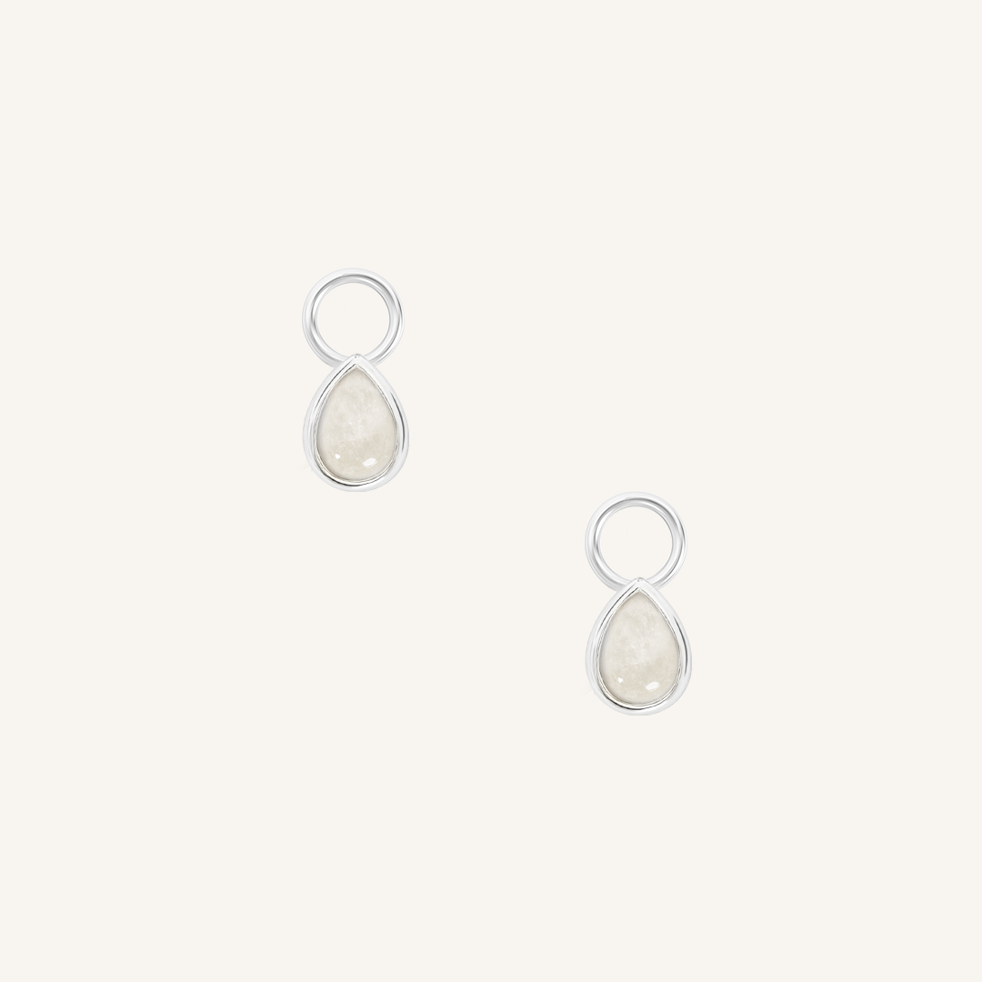 A set of two silver hoop charms with teardrop-shaped Moonstone stones