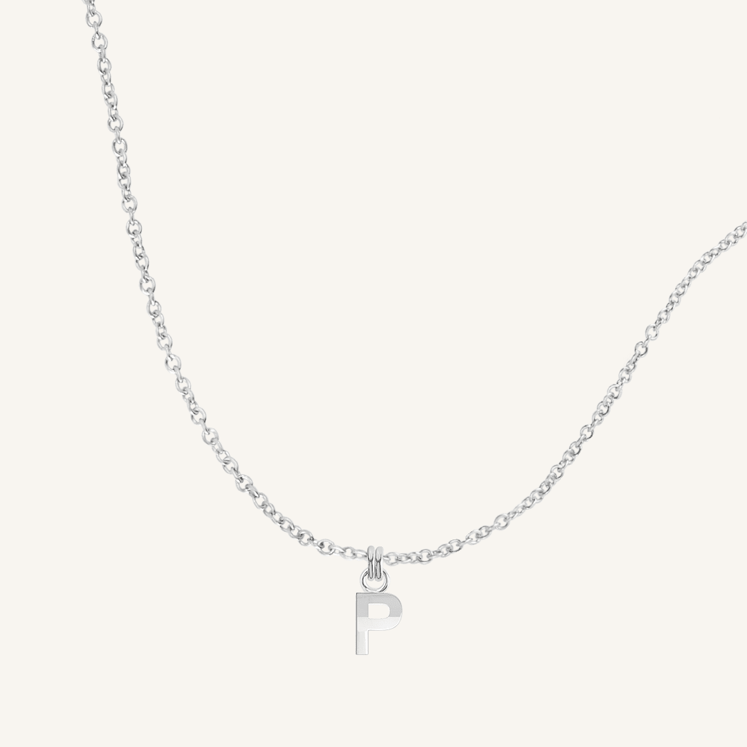 Silver necklace with a 'P' pendant on a light gray background
