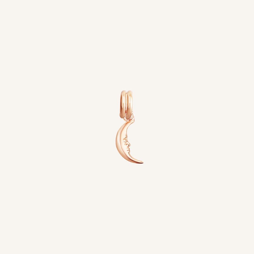 A rose charm in the shape of a crescent moon