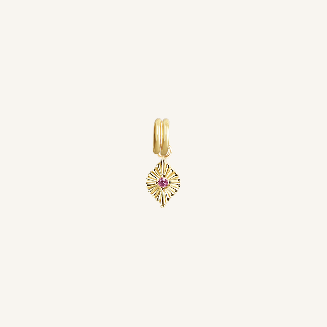 A gold-coloured petite birthstone charm with a pink gemstone, symbolising October.