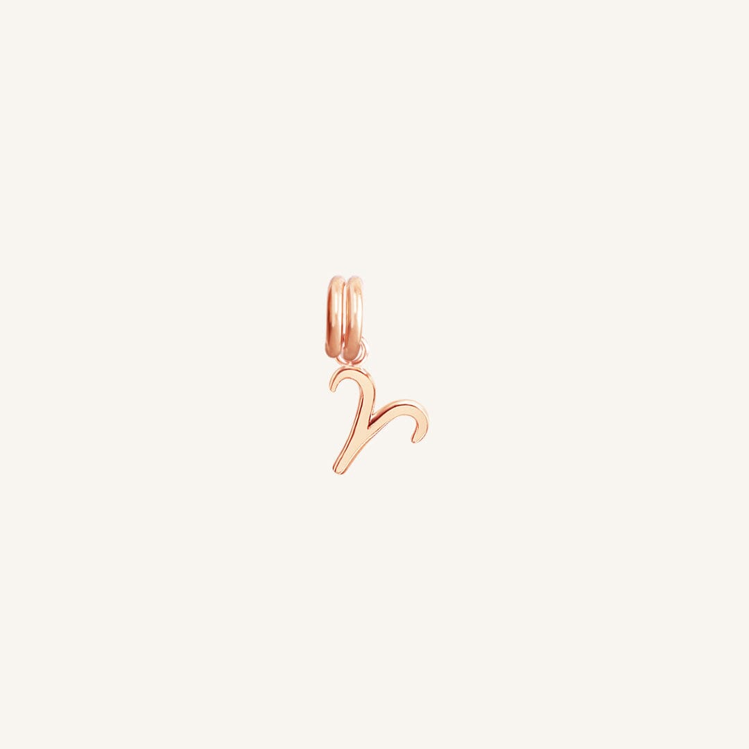 A rose gold Petite Zodiac Charm representing the Aries sign.