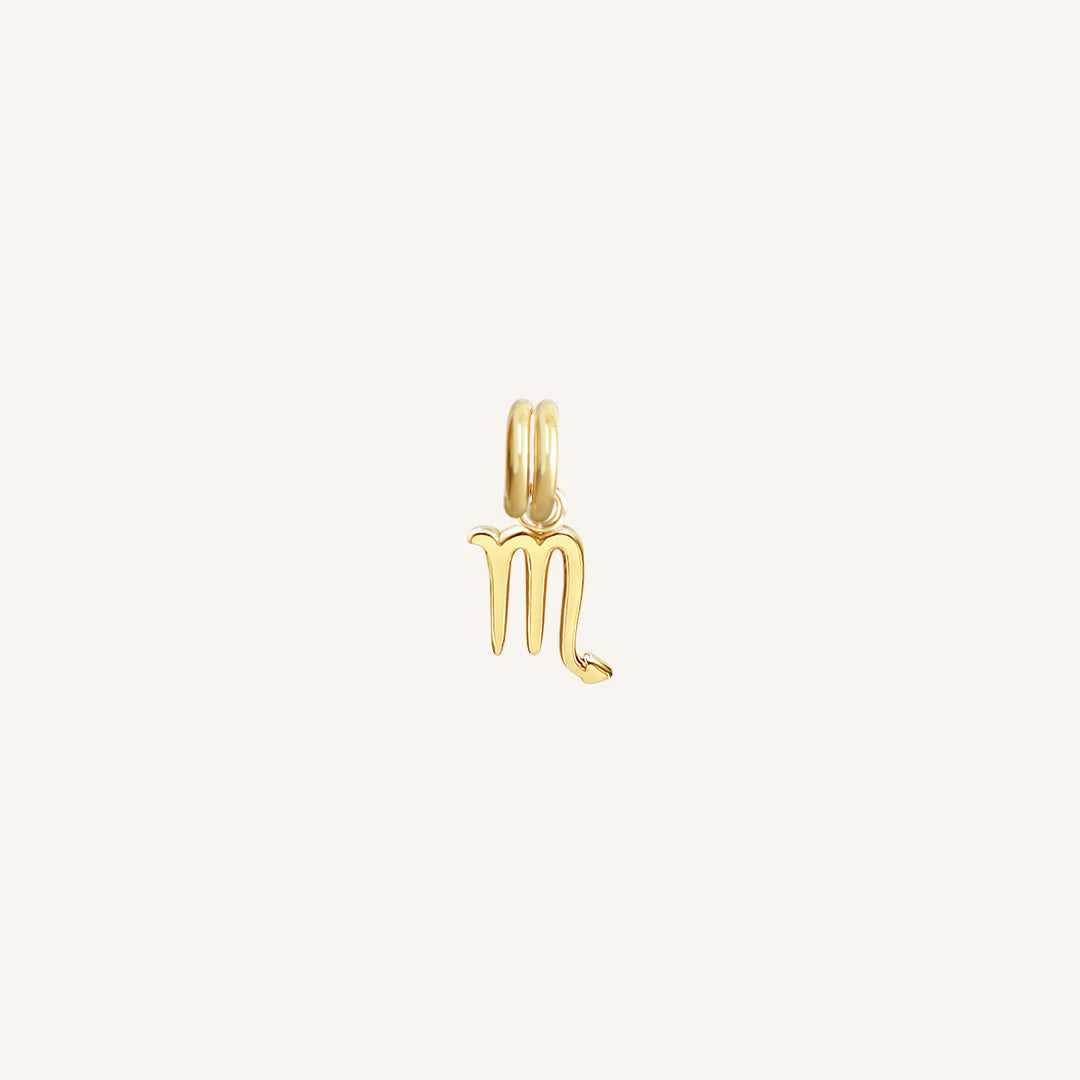 A gold-coloured Petite Zodiac Charm representing the Scorpio sign.