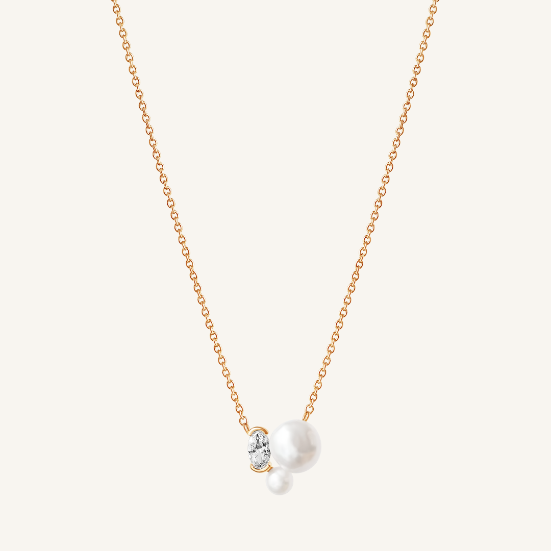 A gold chain necklace with a single pearl pendant in the center, displayed against a white background.