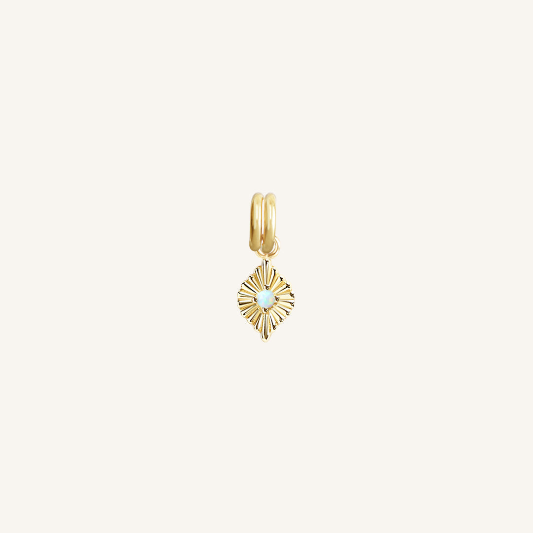 A gold diamond shaped charm with a faux opal in the centre, designed to be attached to a bracelet or necklace