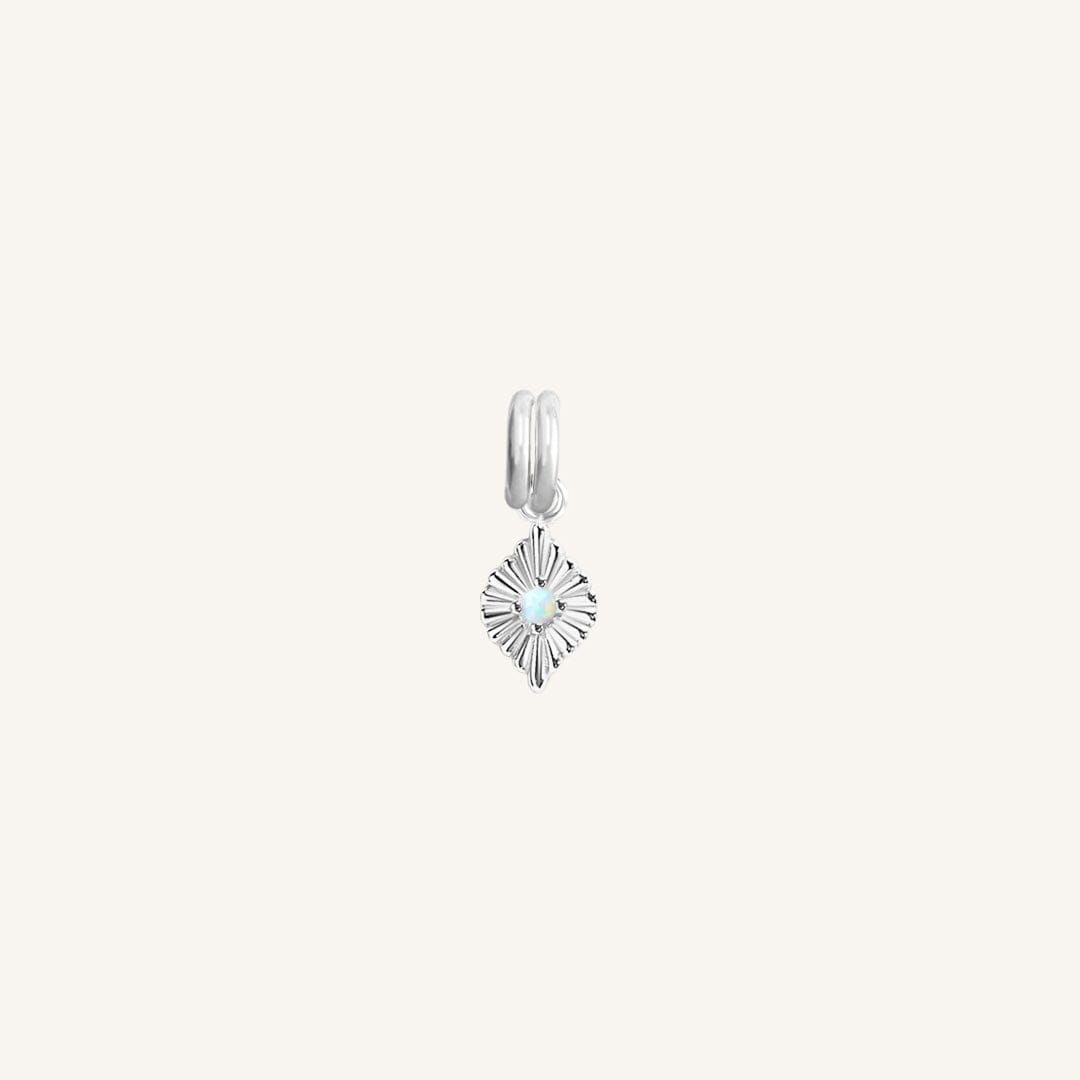 A silver diamond shaped charm with a faux opal in the centre, designed to be attached to a bracelet or necklace