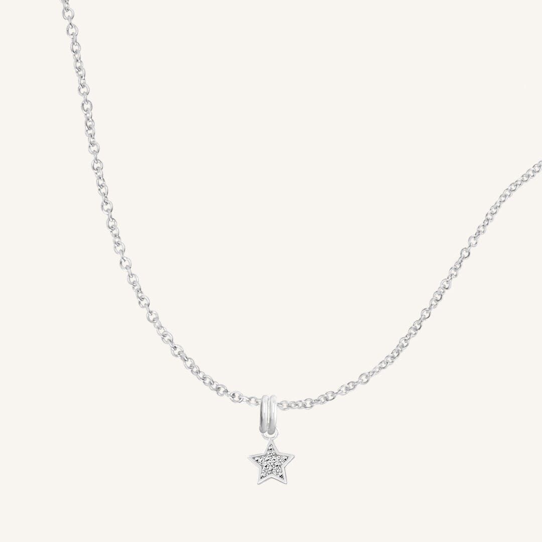 A silver necklace featuring a star-shaped charm pendant with cubic zirconias in the centre.