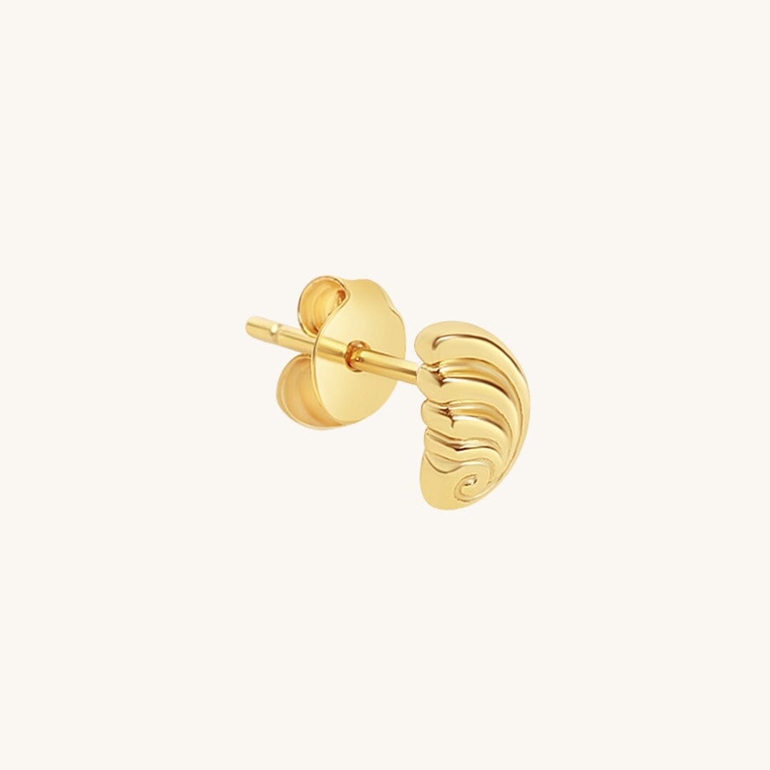Gold earring on a white background