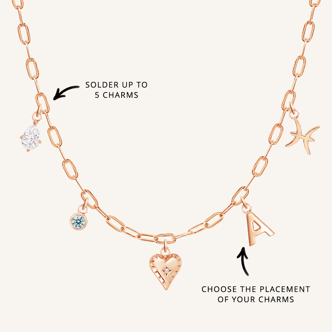 A rose chain necklace with paperclip links and multiple charms, showcasing where to solder charms and the option to choose the placement of the charms.