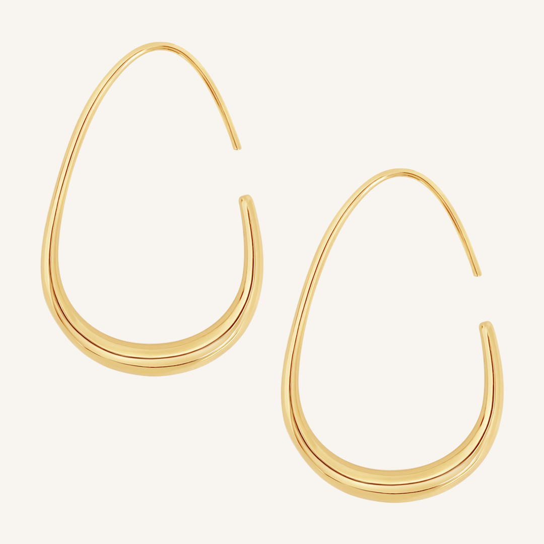 A pair of gold-colored hoop earrings with a geometric design, displayed against a white background