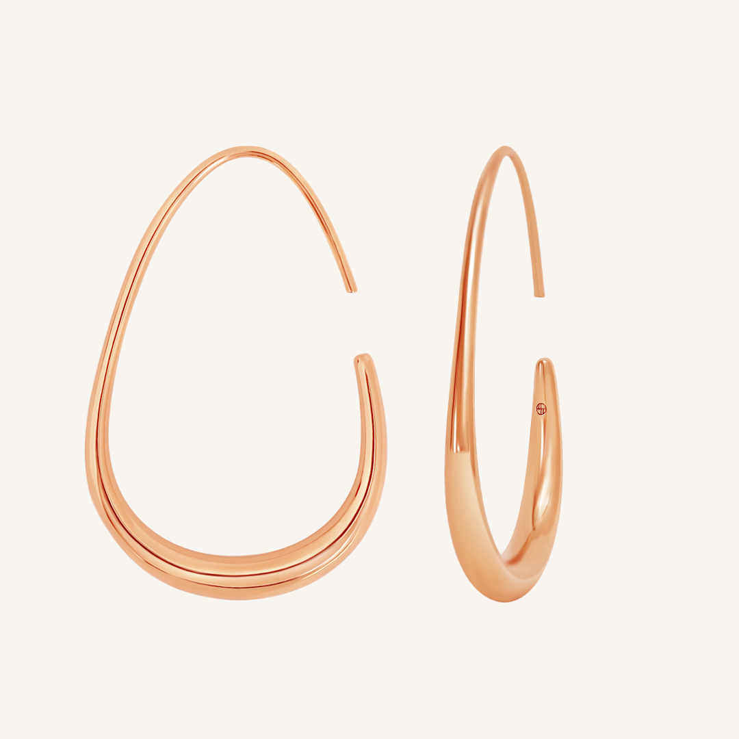 Pair of rose gold hoop earrings on a light background