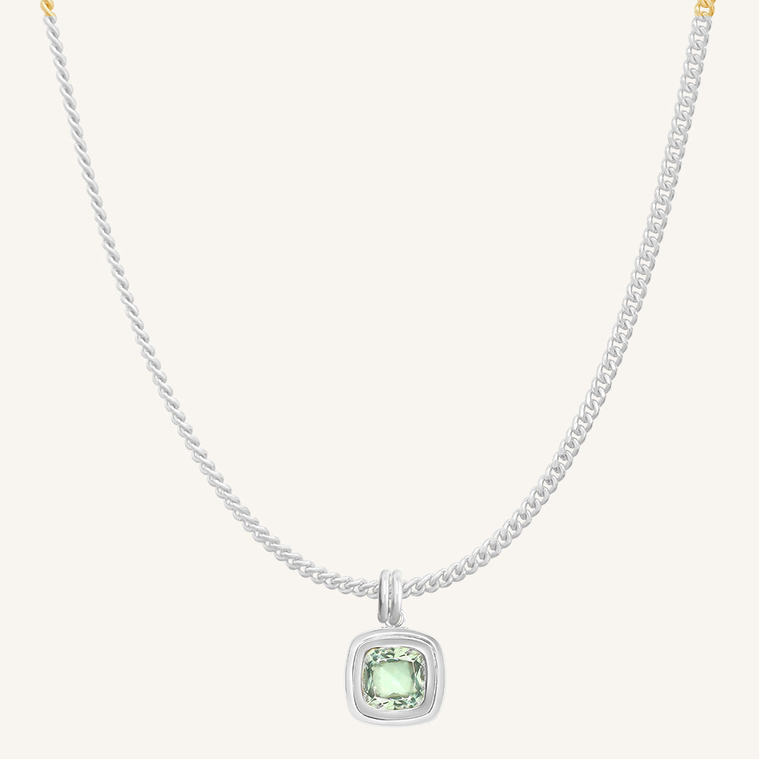 Necklace with a green gemstone pendant on a white background