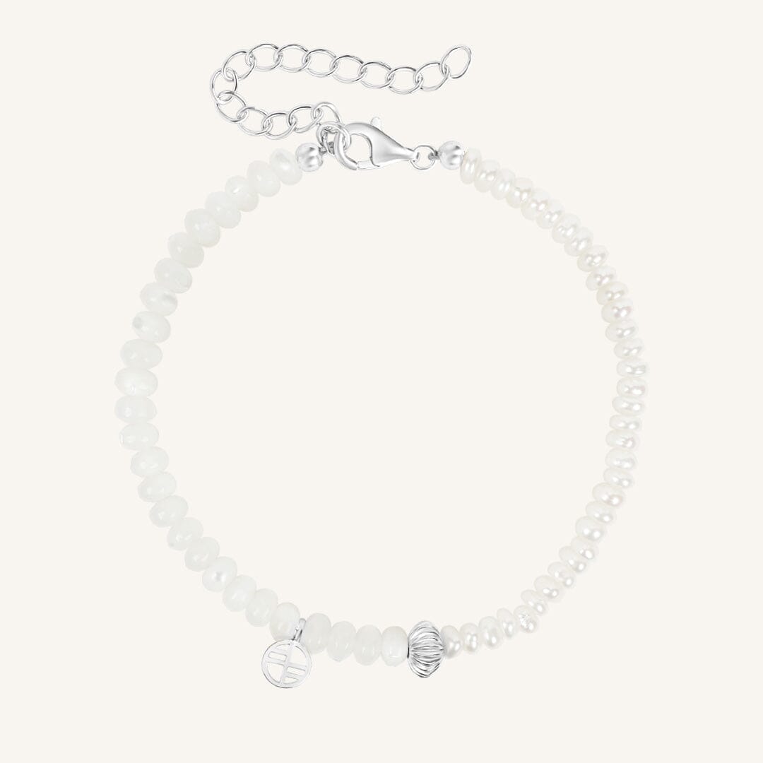 Silver bracelet with beads on a white background