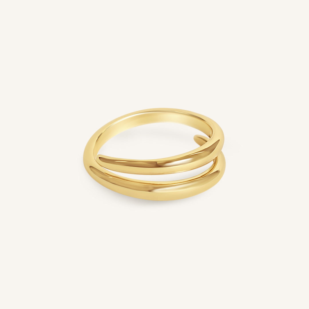 Gold ring with three bands on a white background