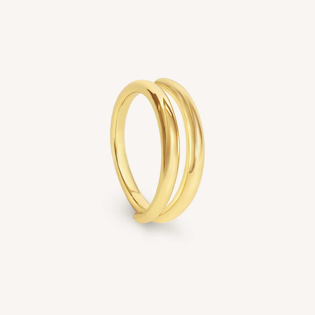 Gold ring on a light gray background
