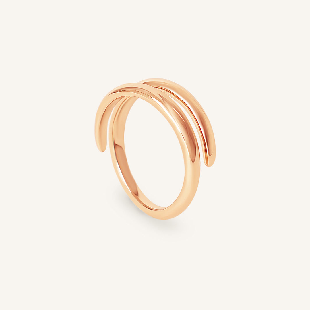 Rose gold ring on a light beige background