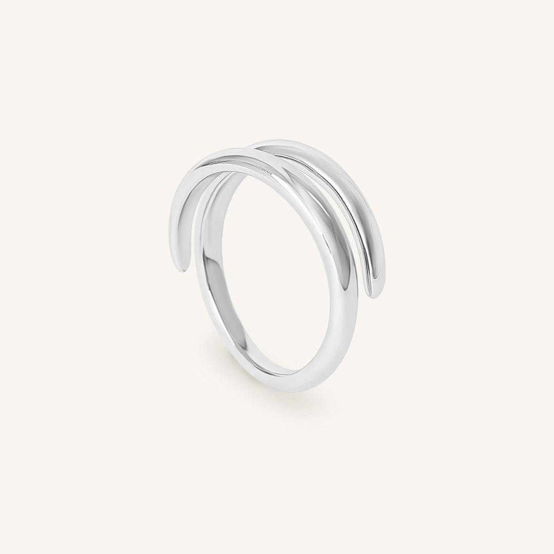 Silver ring with multiple bands on a white background