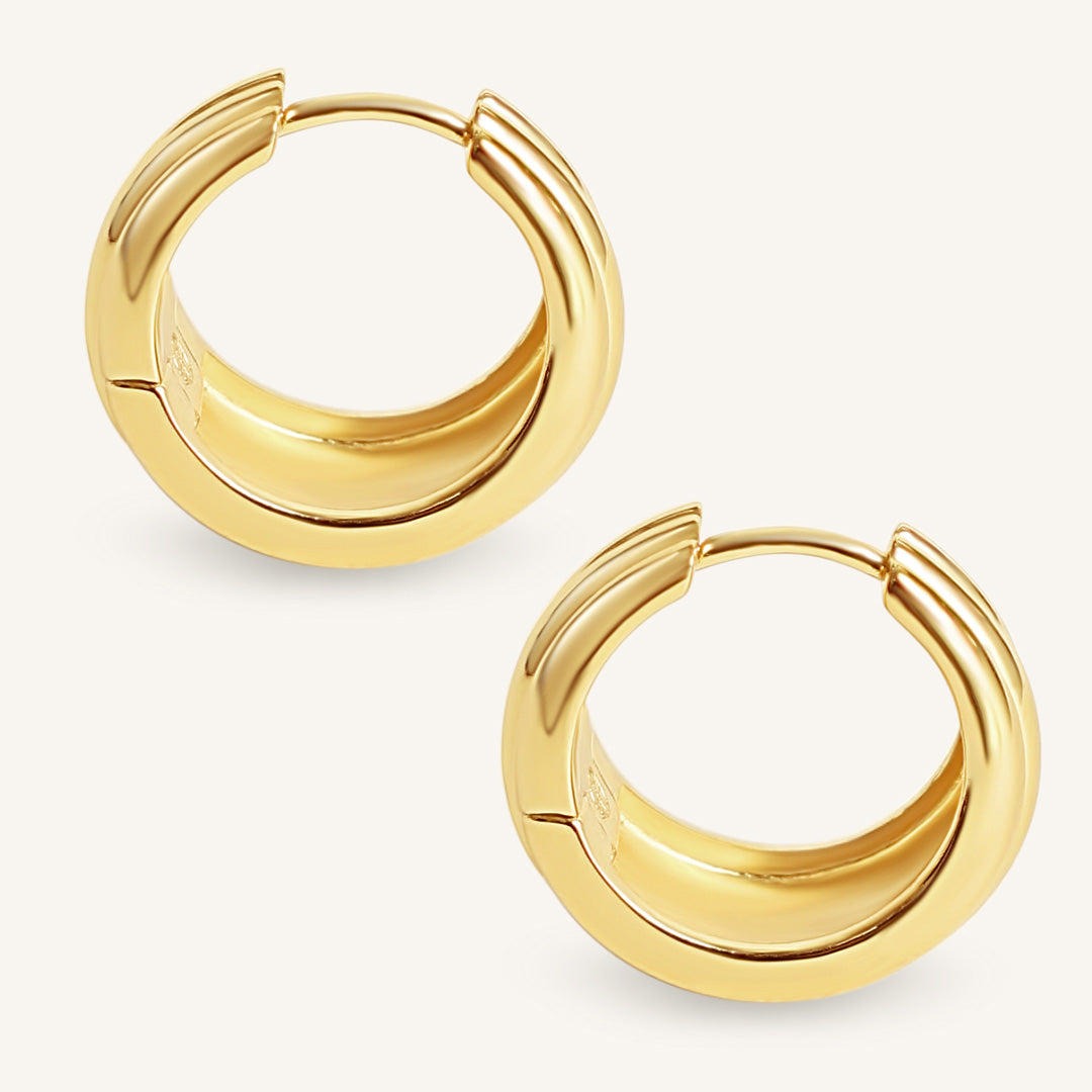 Gold hoop earrings on a white background