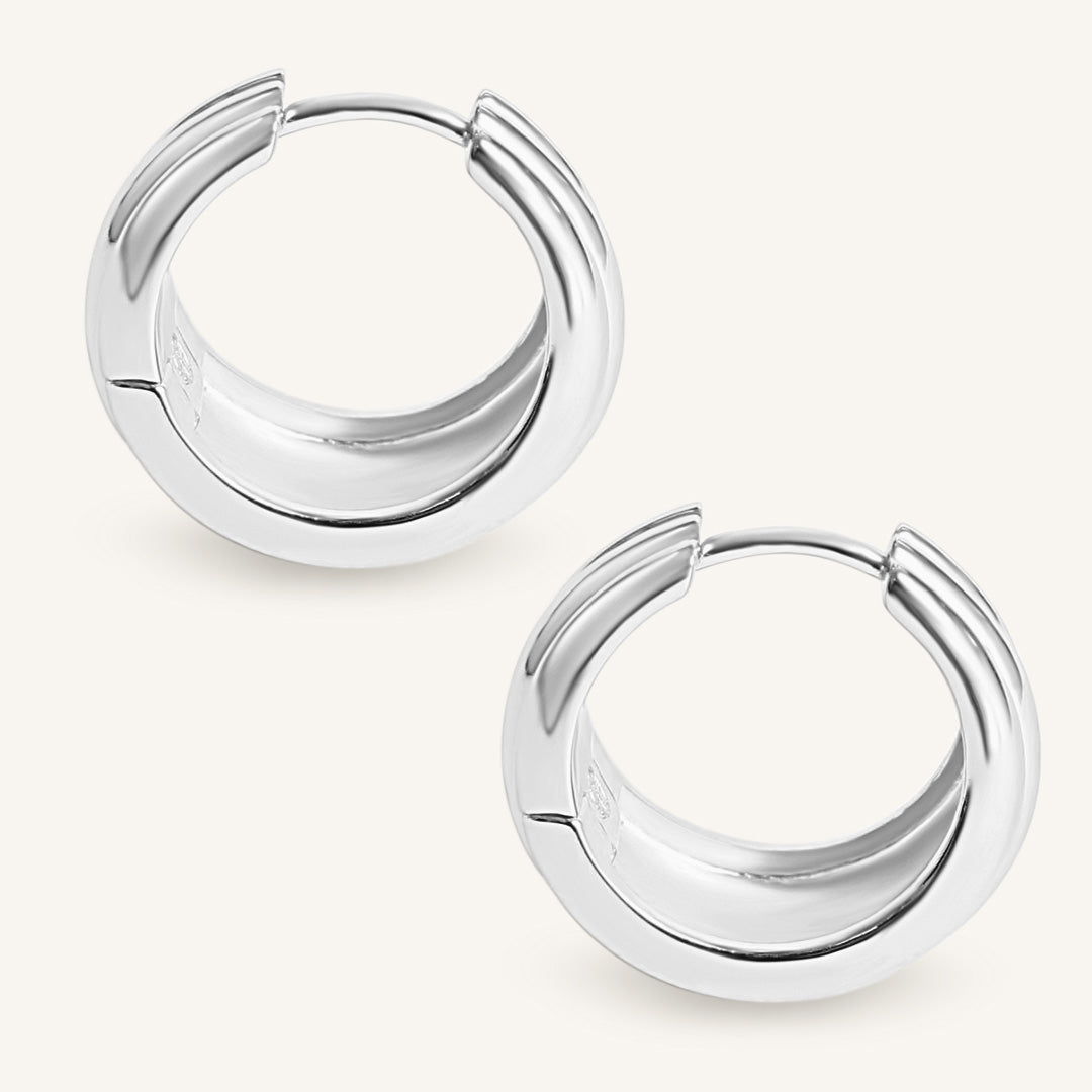 Pair of silver hoop earrings on a white background