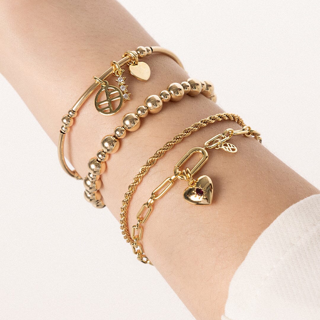 close up on multiple bracelets worn on wrist