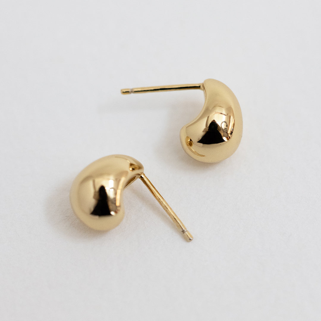 A pair of chunky bulb-shaped earrings in gold tone.