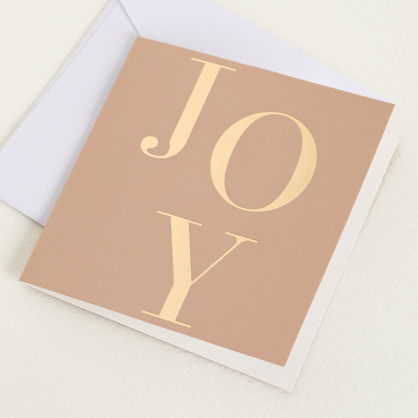 A greeting cards displayed on a neutral background, featuring designs such as 'joy'.