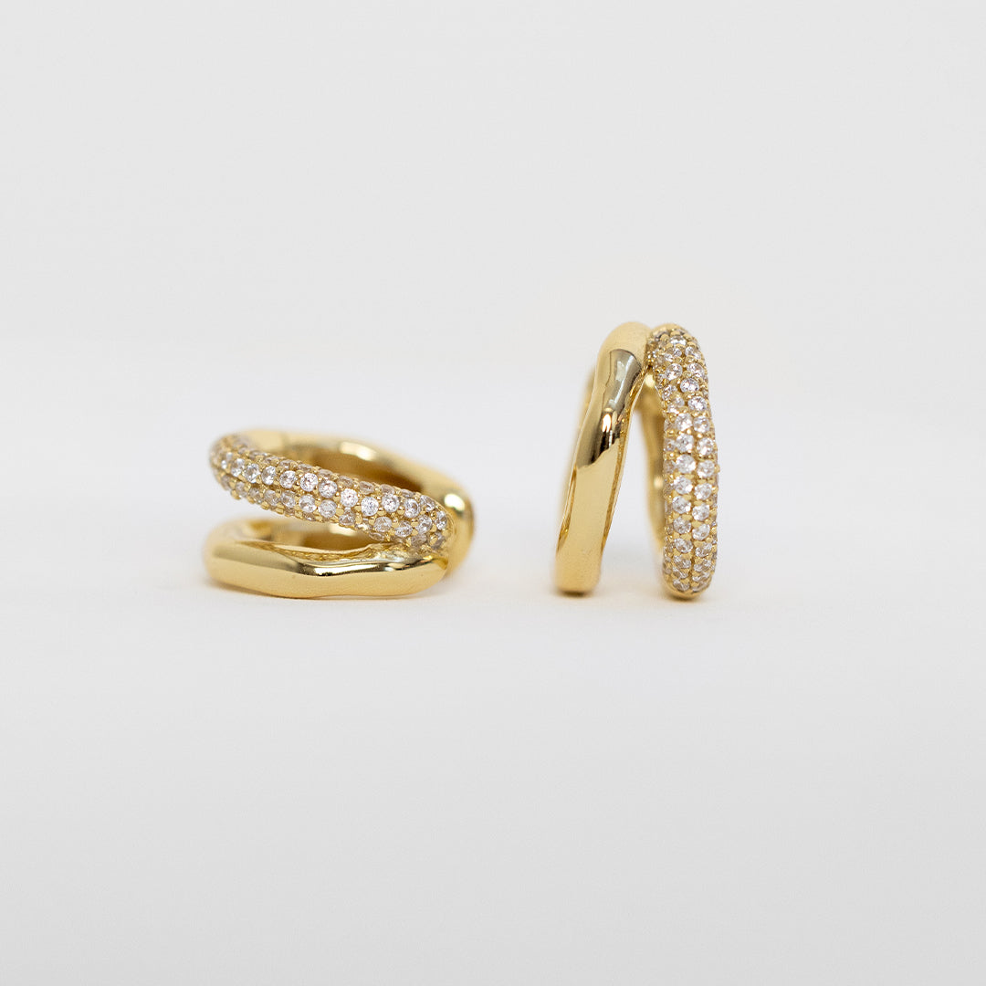close up shot of gold double huggies with cubic zirconias