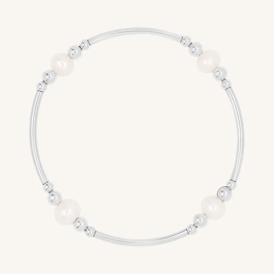 A silver bracelet with natural freshwater pearls, designed with a beaded pattern.