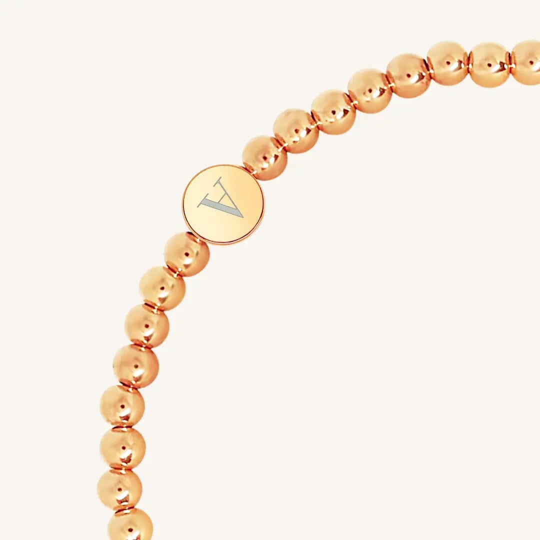 A rose bracelet with a beaded design and an engraveable bead, close up