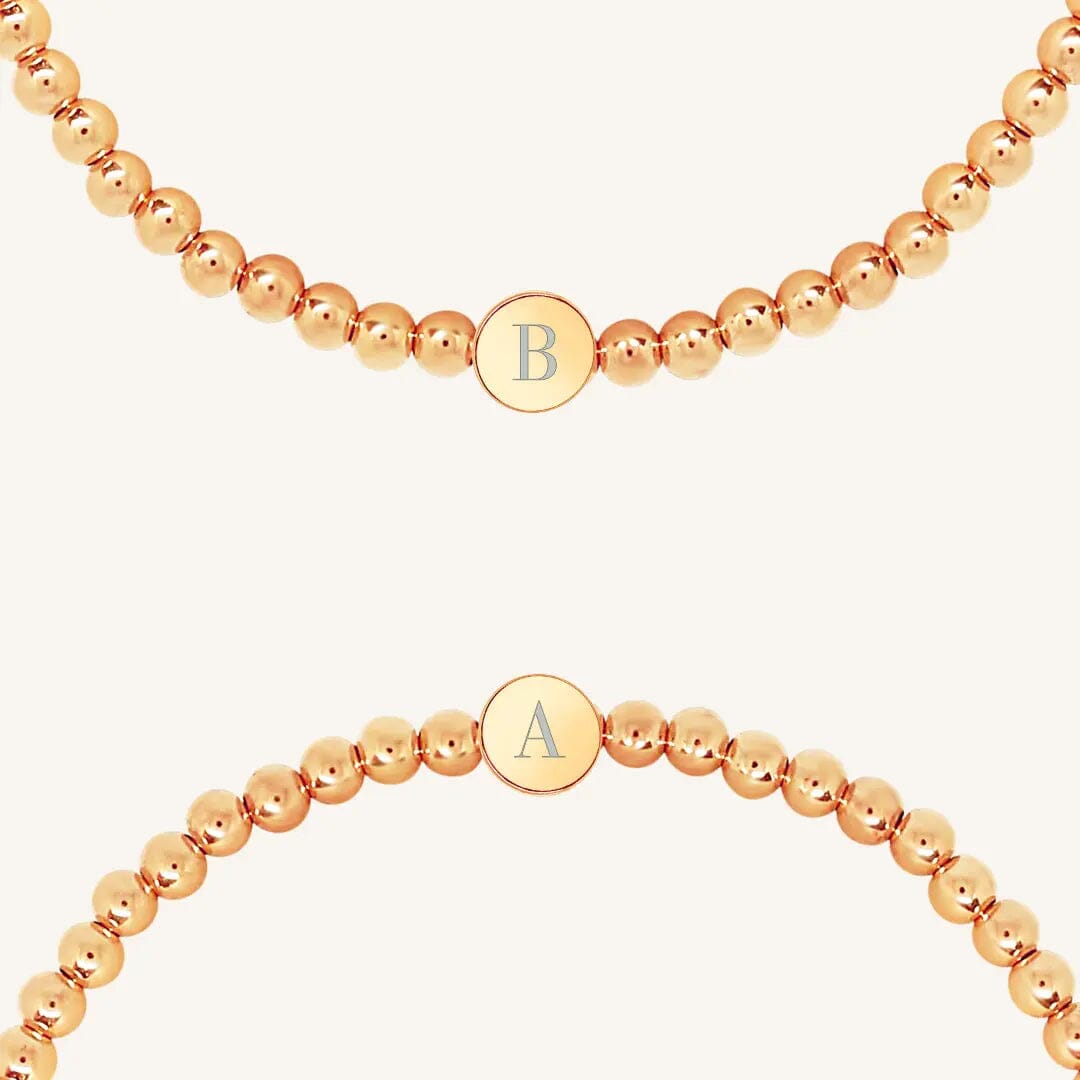 A rose bracelet with a beaded design and an engraveable bead, close up