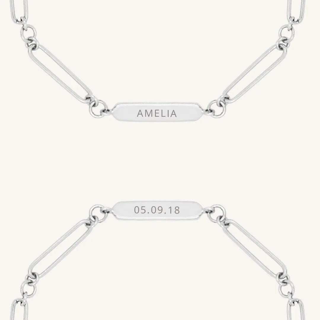 A silver chain bracelet with an engraveable panel.