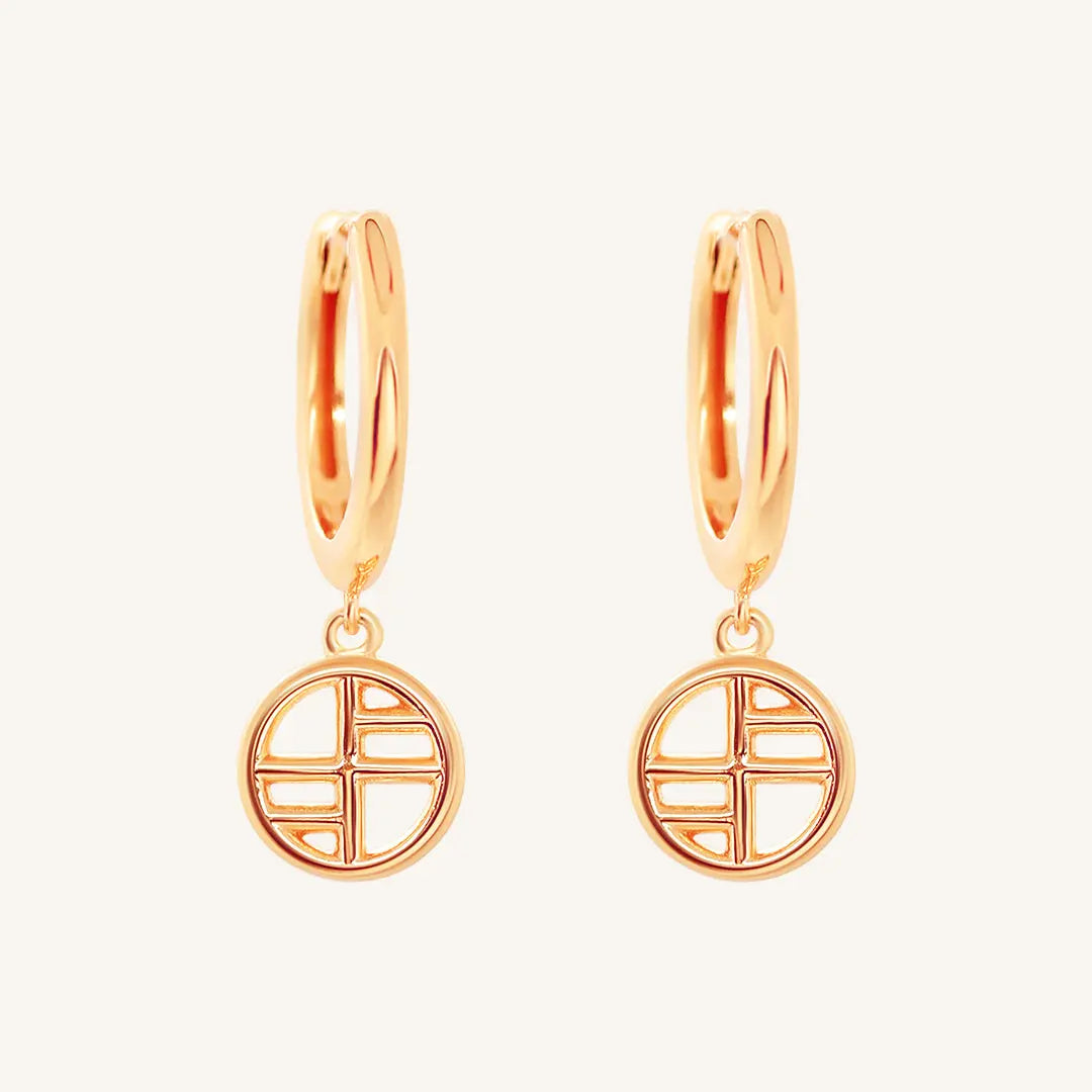 A pair of rose-tone drop earrings with the francesca logo