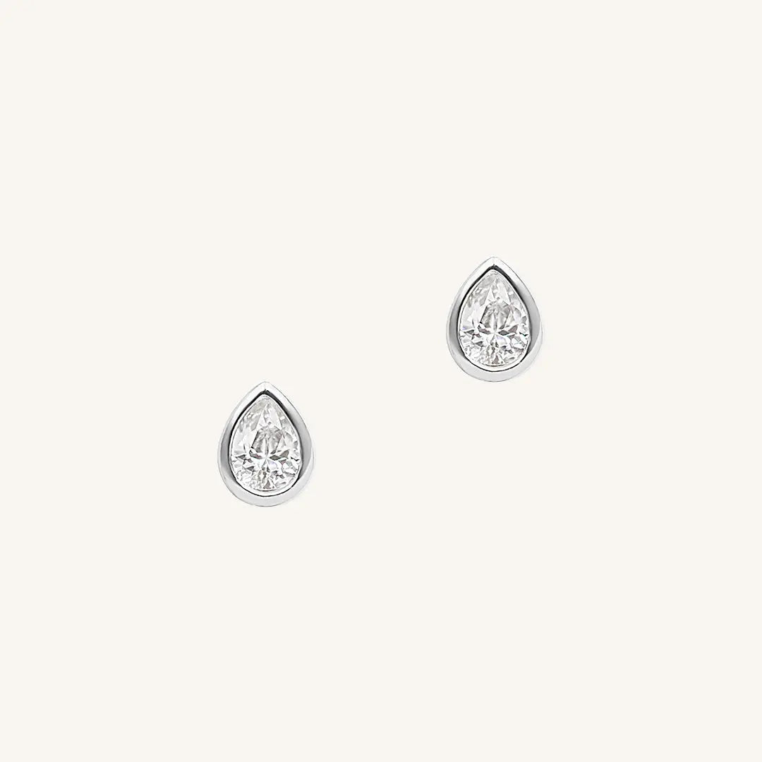 A pair of teardrop-shaped cubic zirconia stud earrings set in silver-tone settings.