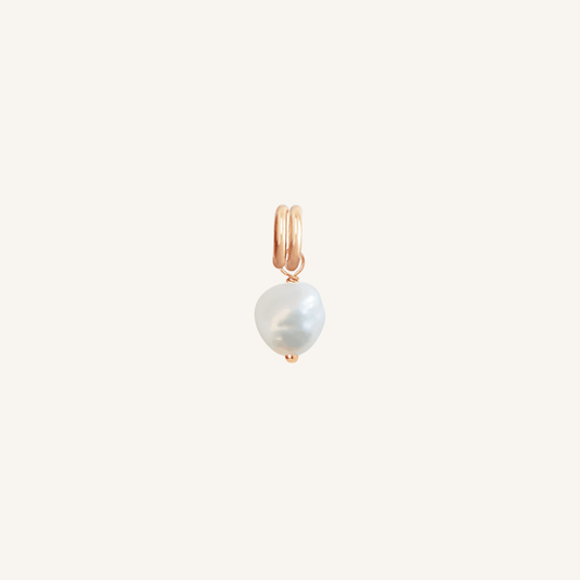 A petite pearl charm with rose findings