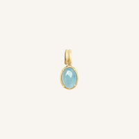 Gold pendant with a blue stone on a white background