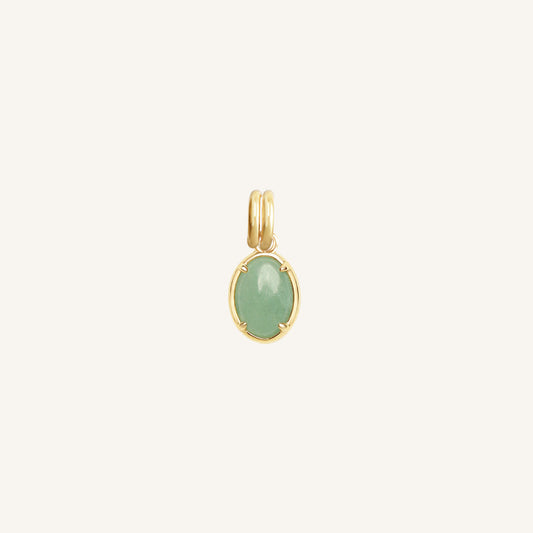 Gold pendant with a green stone on a white background