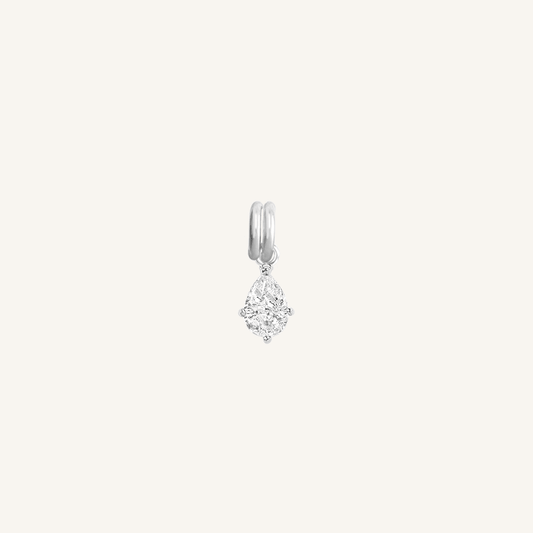 A teardrop-shaped cubic zirconia charm with a silver metal tone