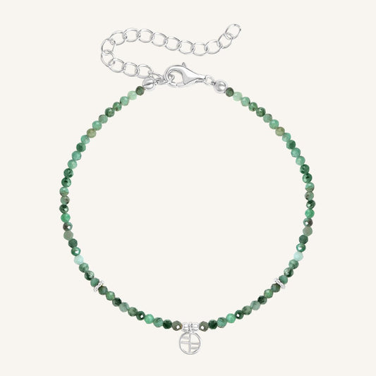 A beaded bracelet with green gemstones and a silver-tone clasp and charm.