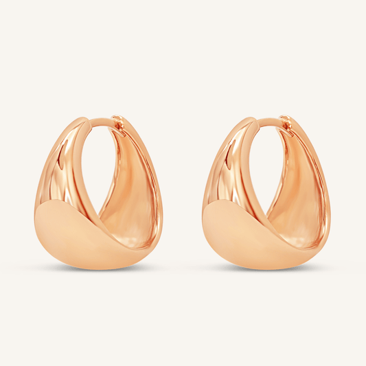 A pair of rose chunky hoop earrings on a white background.