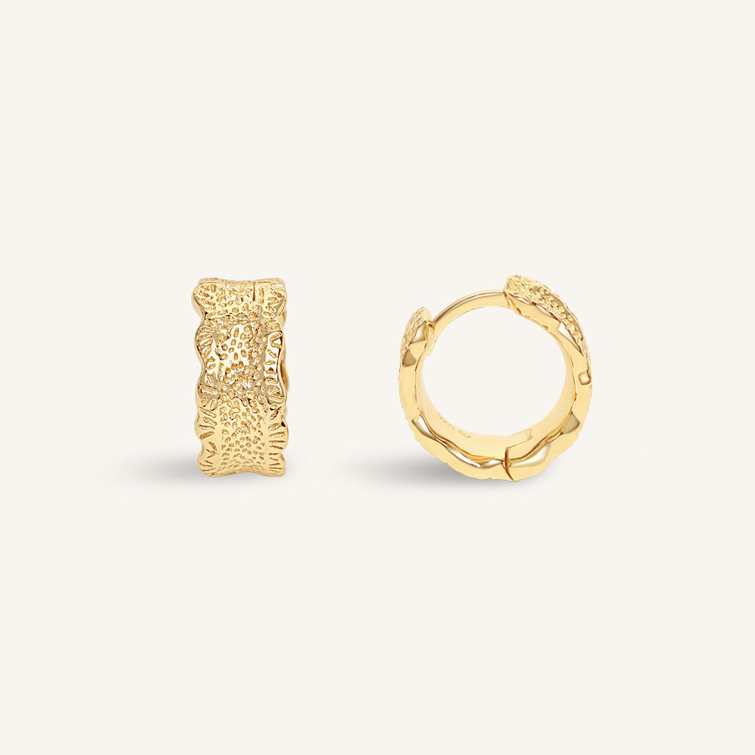Gold hoop earrings on a white background