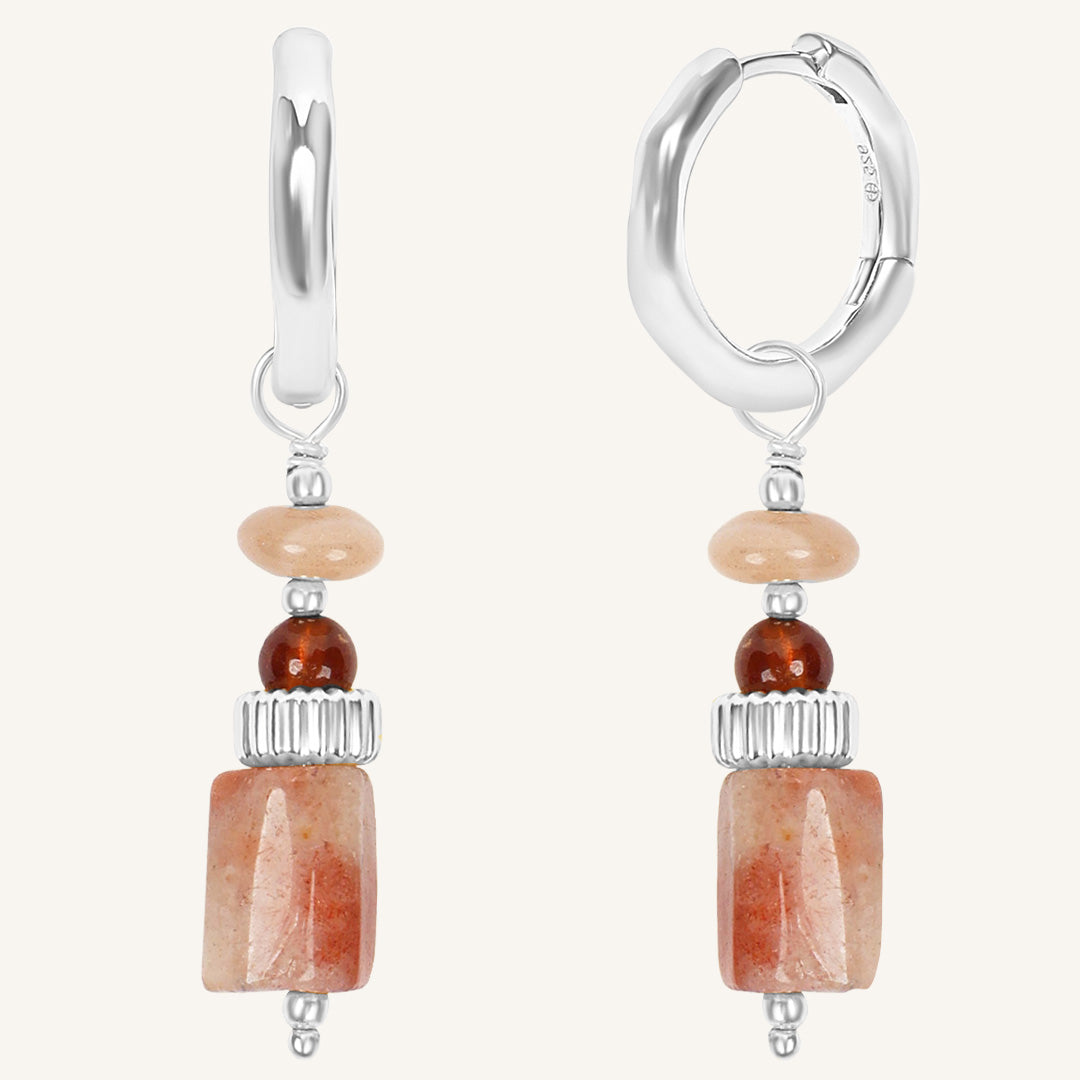 Pair of hoop earrings with stone beads on a white background
