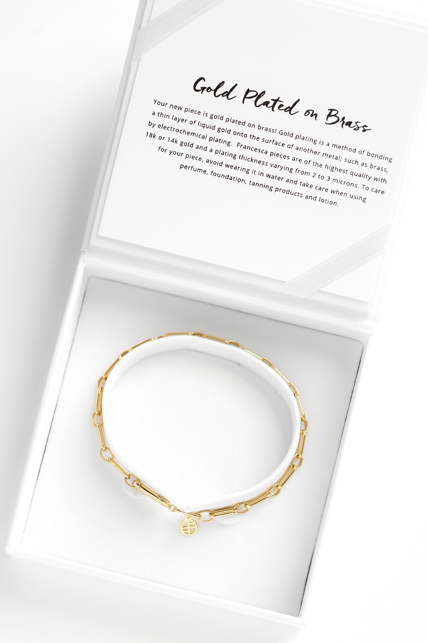 A gold-toned link bracelet in white box