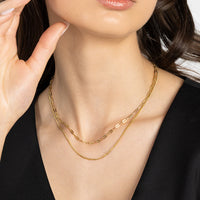 Silver chain necklace on a light gray background