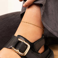 Gold anklet on a white background