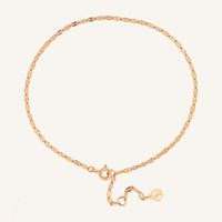 Rose gold anklet on a white background