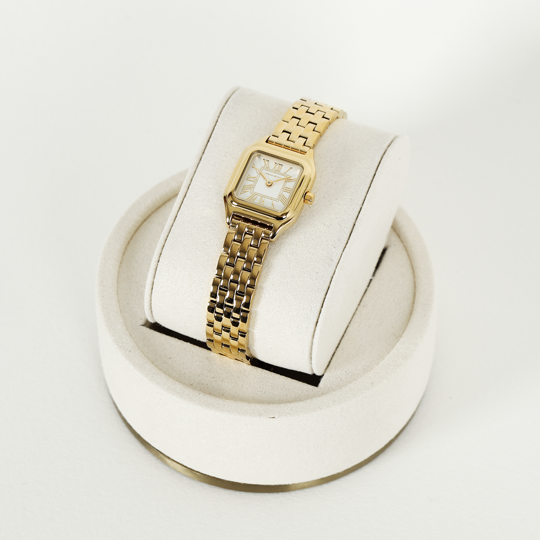 A gold-toned Louis Watch with a link bracelet and a square face featuring Roman numerals.