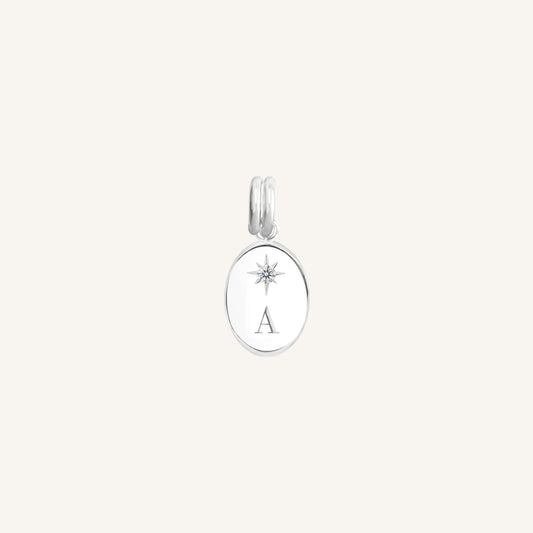 Silver pendant with a star design and letter 'A' on a light gray background