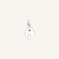 Silver pendant with 'H' and gemstone on a white background
