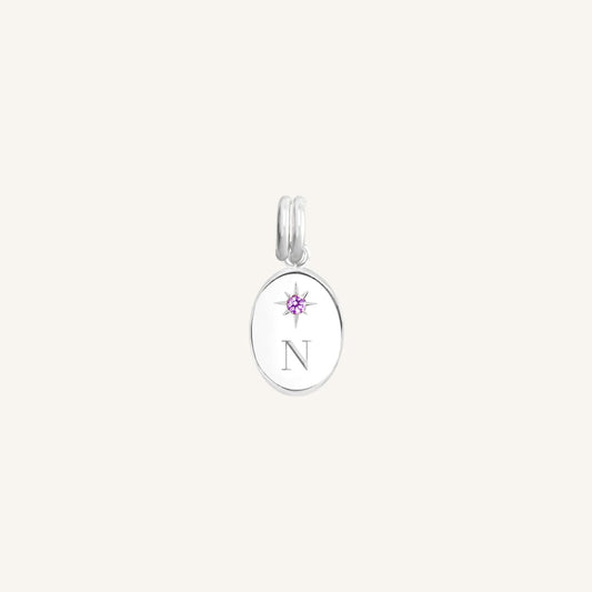 Silver pendant with a pink gemstone on a white background