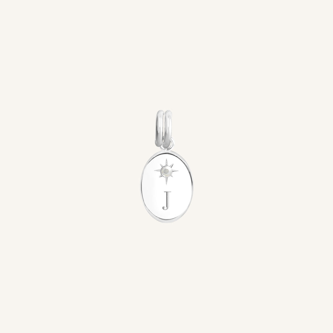 Silver pendant with letter 'J' on a white background