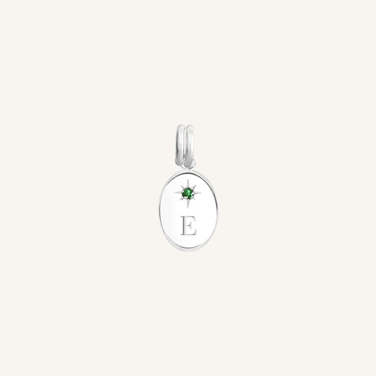 Silver pendant with a green gemstone and letter 'E' on a white background